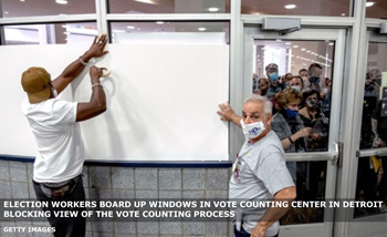 Election workers board up windows thereby blocking view of the vote counting process