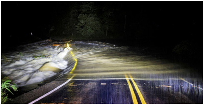 Water flows over the top of a North Carolina  dam